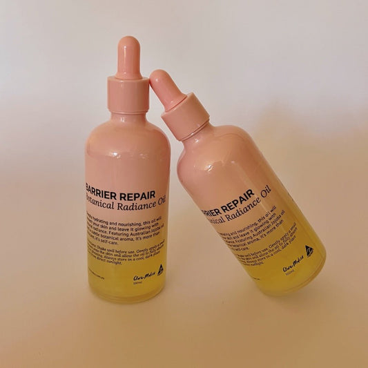 Clare Makes Barrier Repair Body Oil duo shown with pink and gold glass bottles