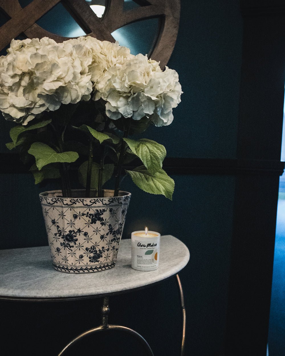 Banjo: Australian Bush candle on minimalist desk with white florals - bestselling native fragrance by Clare Makes