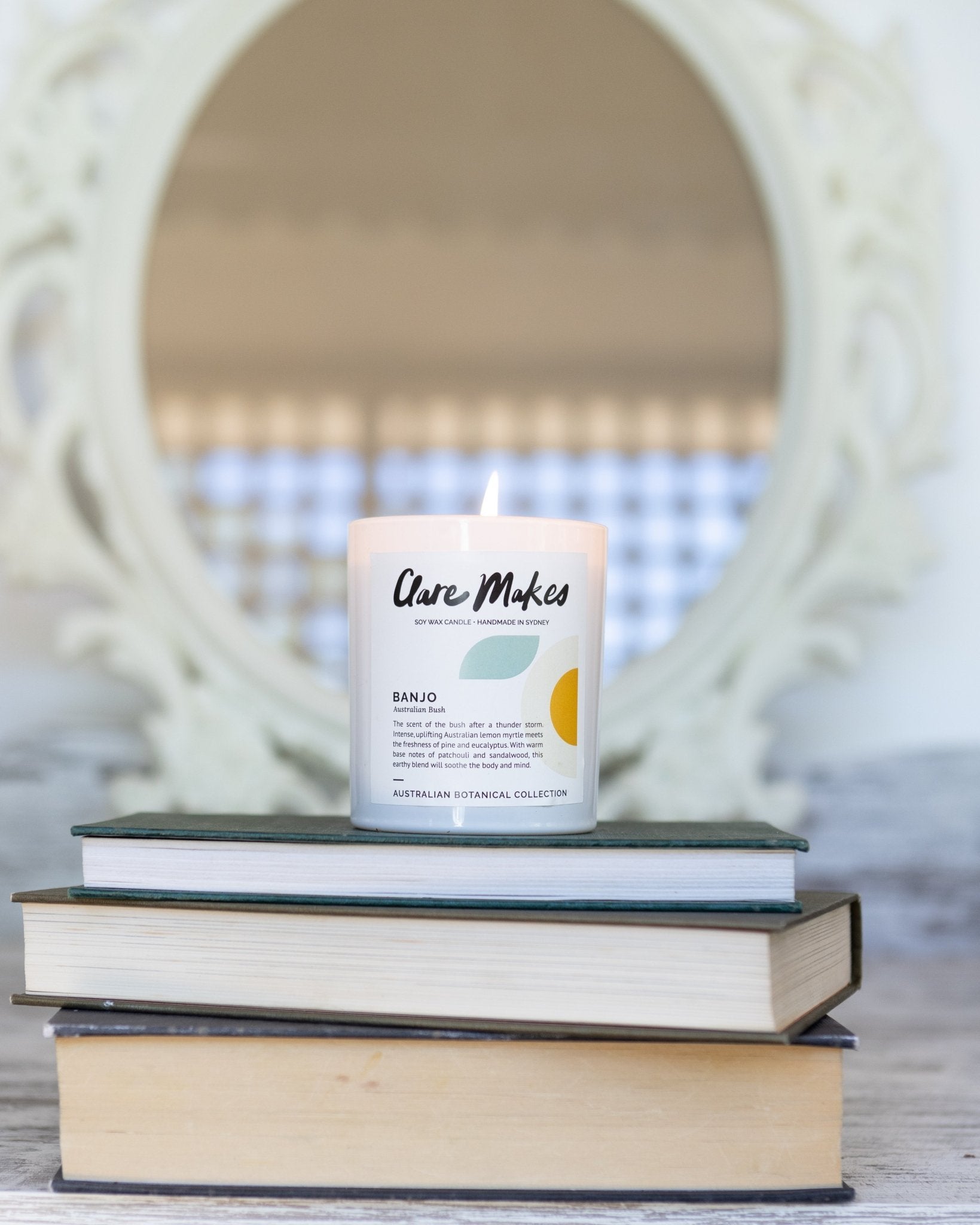 Clare Makes Australian Bush candle on stack of books - Banjo lemon myrtle and eucalyptus scent