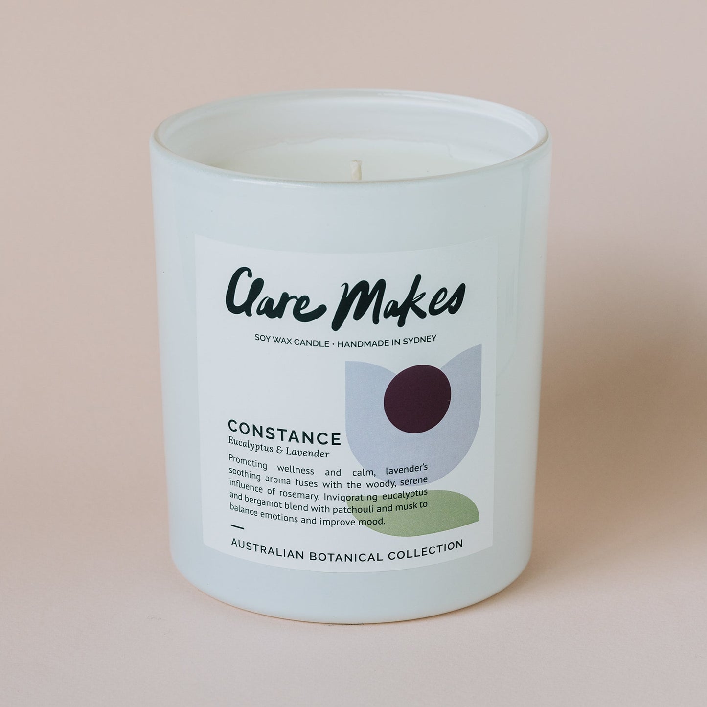Clare Makes Constance candle with eucalyptus and lavender, styled on a pink background