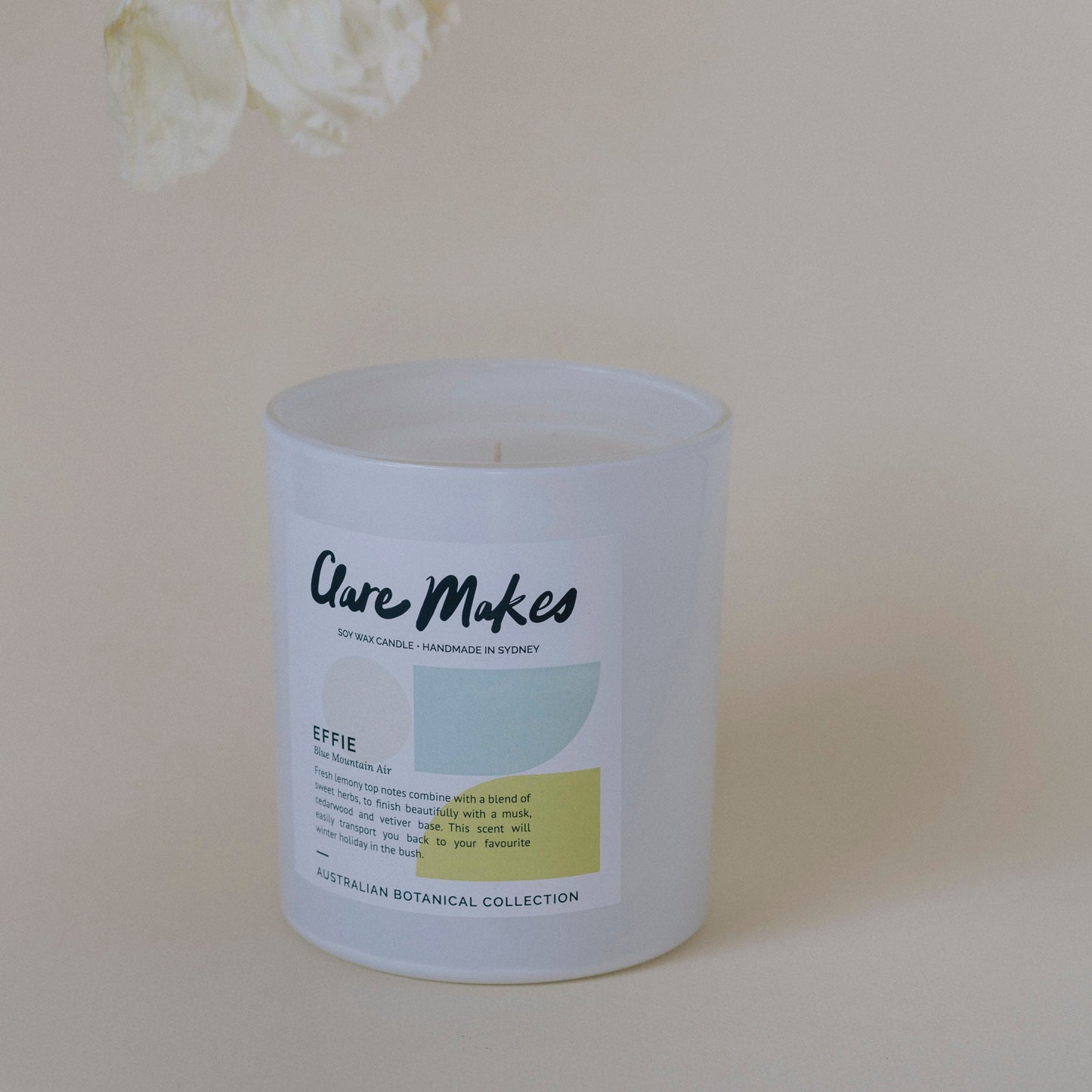 Effie: Blue Mountain Air candle in minimalist setting with pastel background