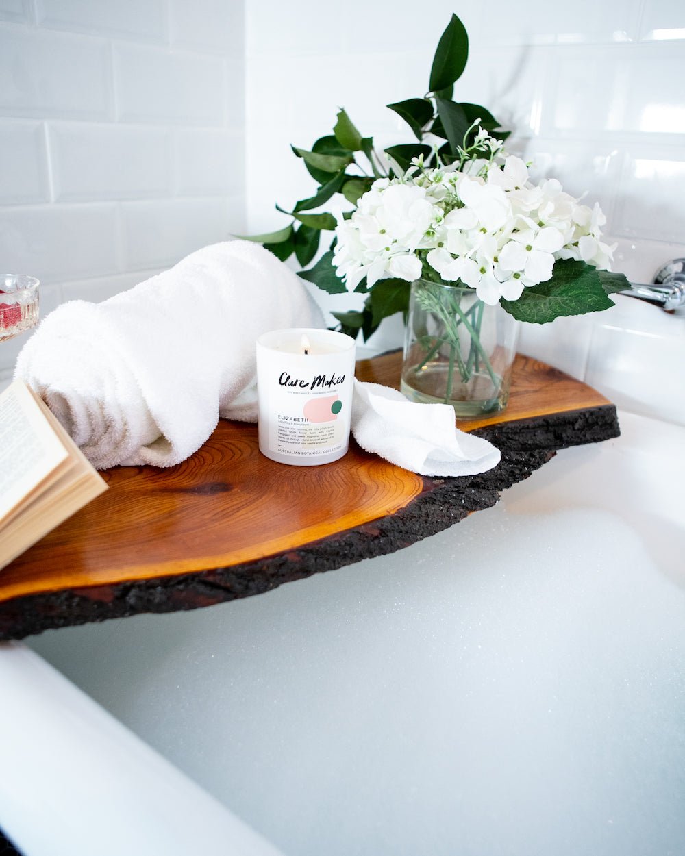 Elizabeth candle styled in a spa-like setting with towel and greenery, Clare Makes