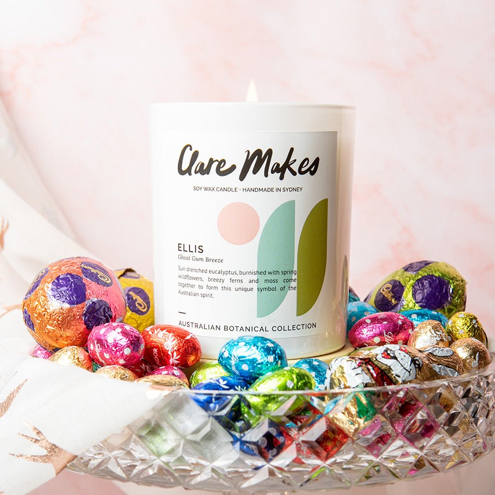 Ellis: Ghost Gum Breeze candle by Clare Makes surrounded by vibrant flowers and pastel decor.