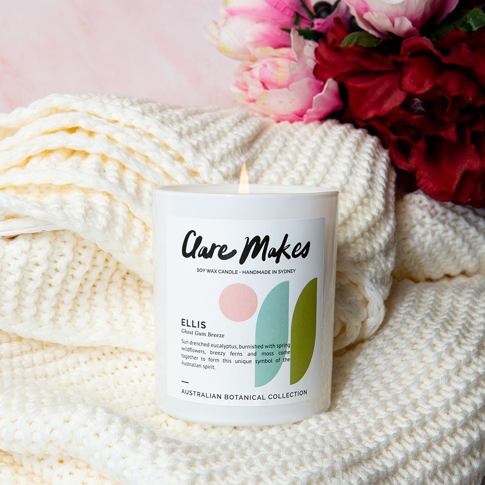 Ellis: Ghost Gum Breeze candle by Clare Makes with soft fabric and pink florals in background.
