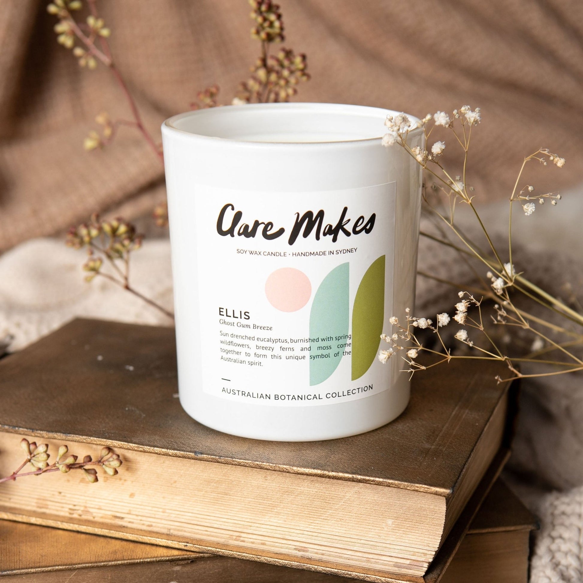 Ellis: Ghost Gum Breeze candle by Clare Makes styled on a wooden table with warm lighting.