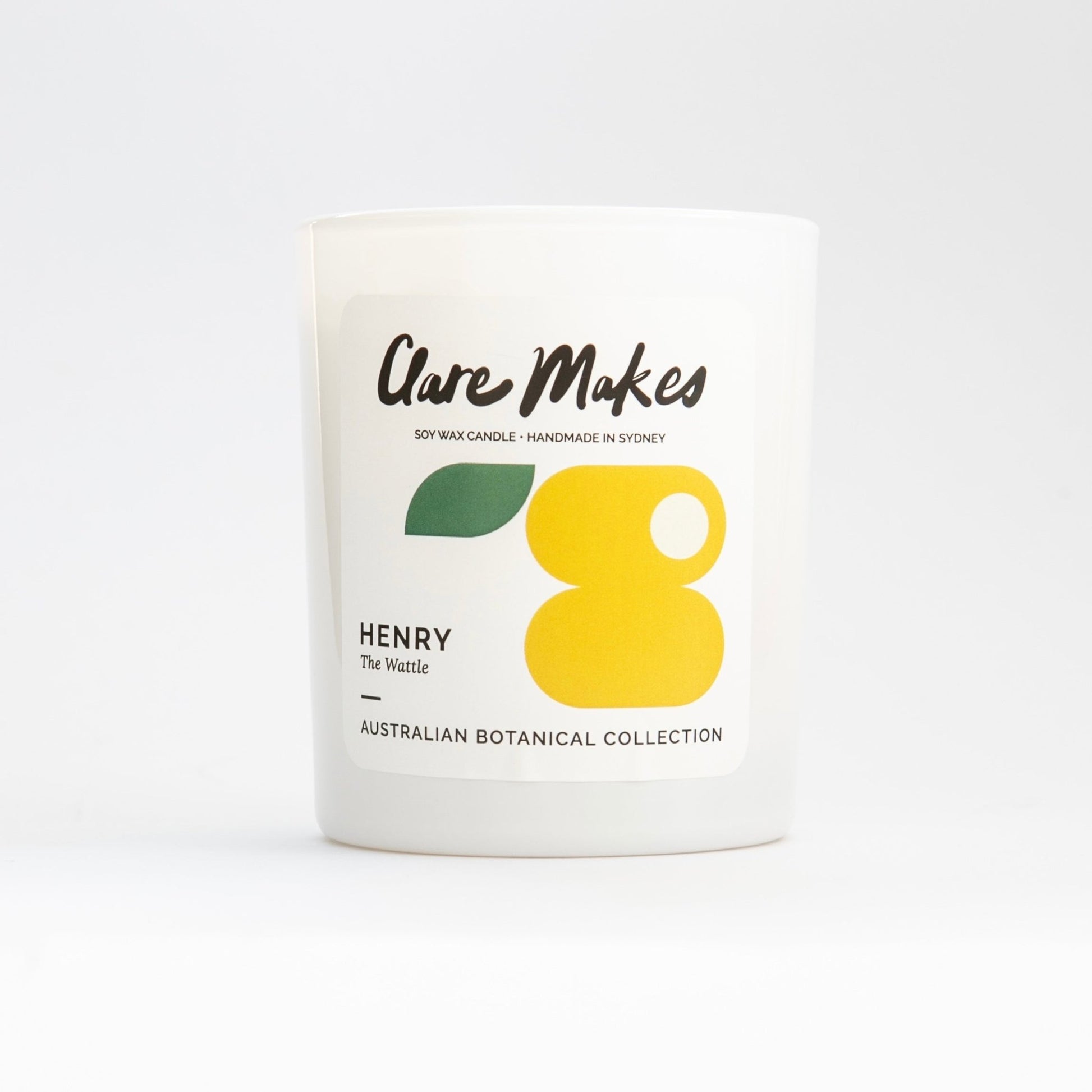 Henry: The Wattle candle by Clare Makes, close-up product shot with label on matte white jar