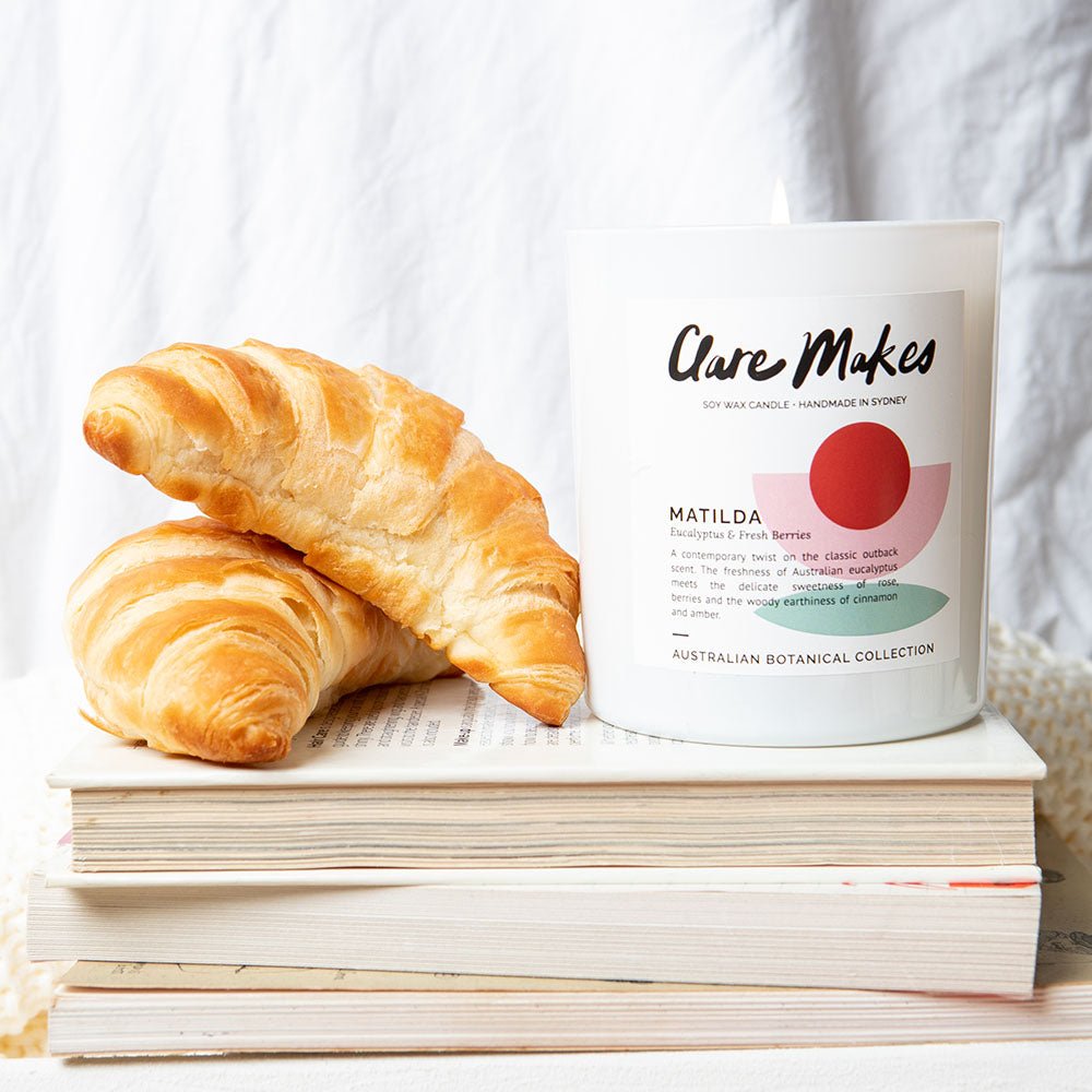 Matilda eucalyptus and berries candle by Clare Makes in white jar with green and red label