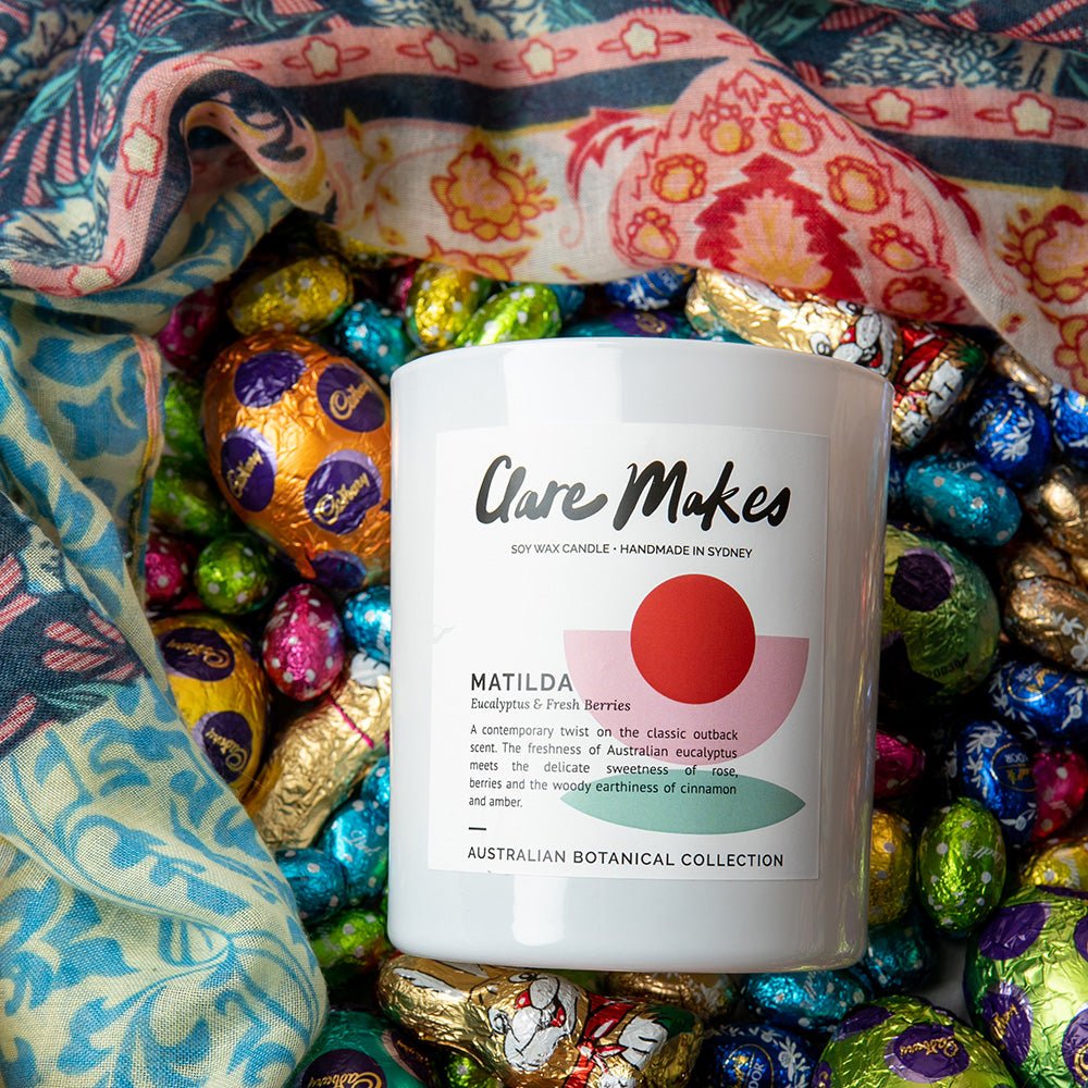 Matilda eucalyptus and berries candle by Clare Makes in white jar with green and red label