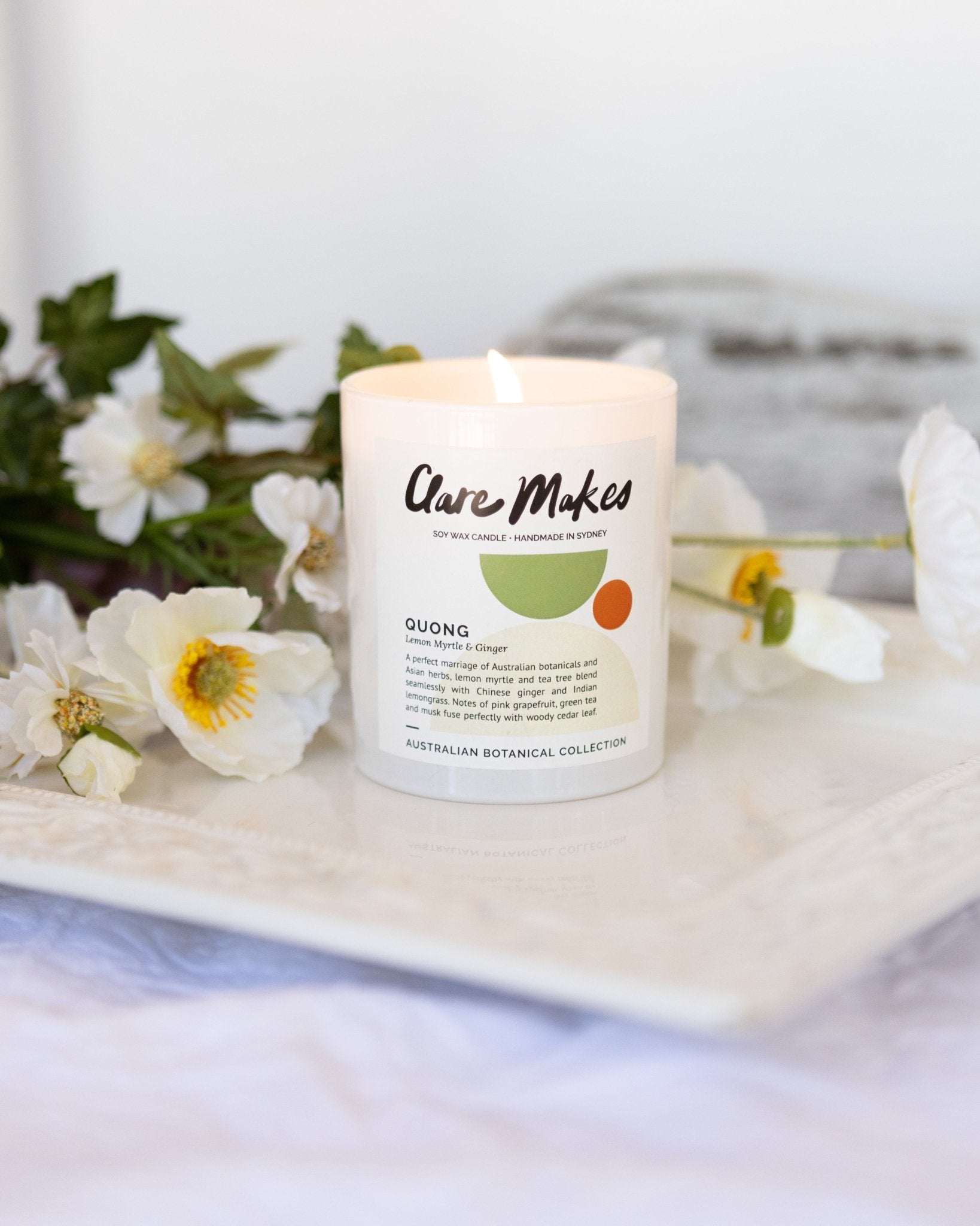 Clare Makes Quong candle in white glass jar labelled Lemon Myrtle & Ginger, part of the Australian Botanical Collection