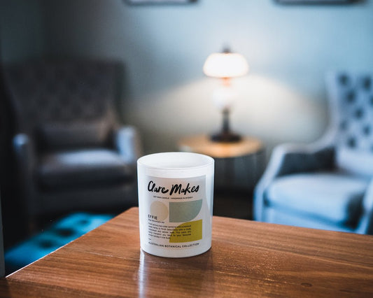 Blue Mountain Air Large Candle 280g displayed on white windowsill in bedroom with blue mountain view and morning light