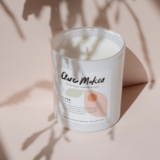 Clyde: Kakadu Plum candle by Clare Makes styled with soft shadows and native foliage
